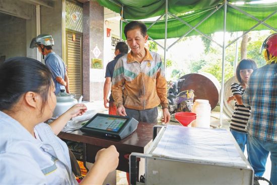  胶农在智慧收胶机上查看场外期权补贴金额。 袁琛 实习生 廖浩晟 摄
